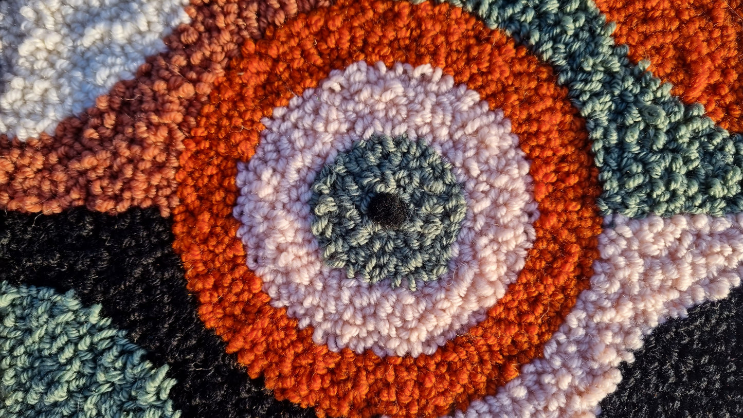 Wall hanging made with punch needle or tufting wool, warm tones of beige, brown, and orange. One-of-a-kind piece, 23 × 31 cm