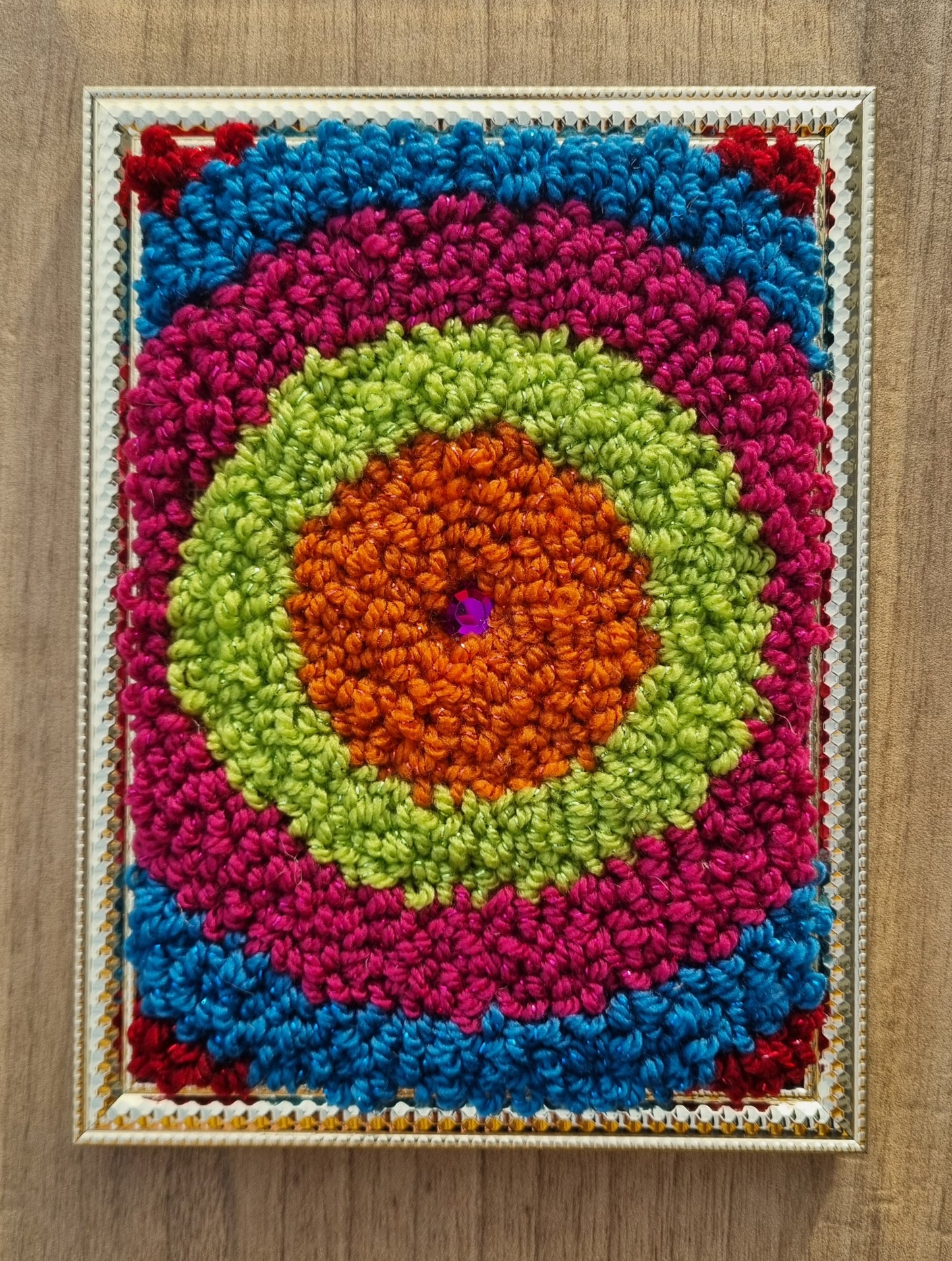 Wall hanging made with punch needle or tufting wool, warm tones of beige, brown, and orange. One-of-a-kind piece, 15 × 20 cm