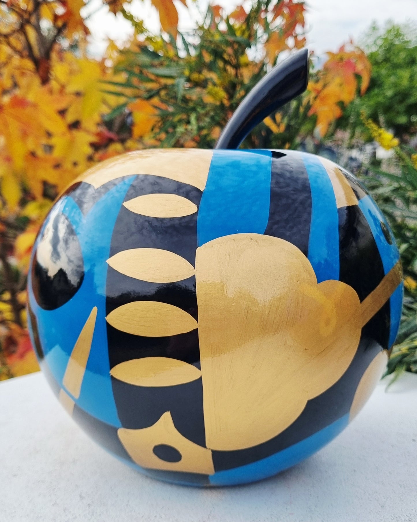 Fruit sculpture. Blue, black and golden apple, multicolored resin. Height 26 centimeters (10,2 inches)