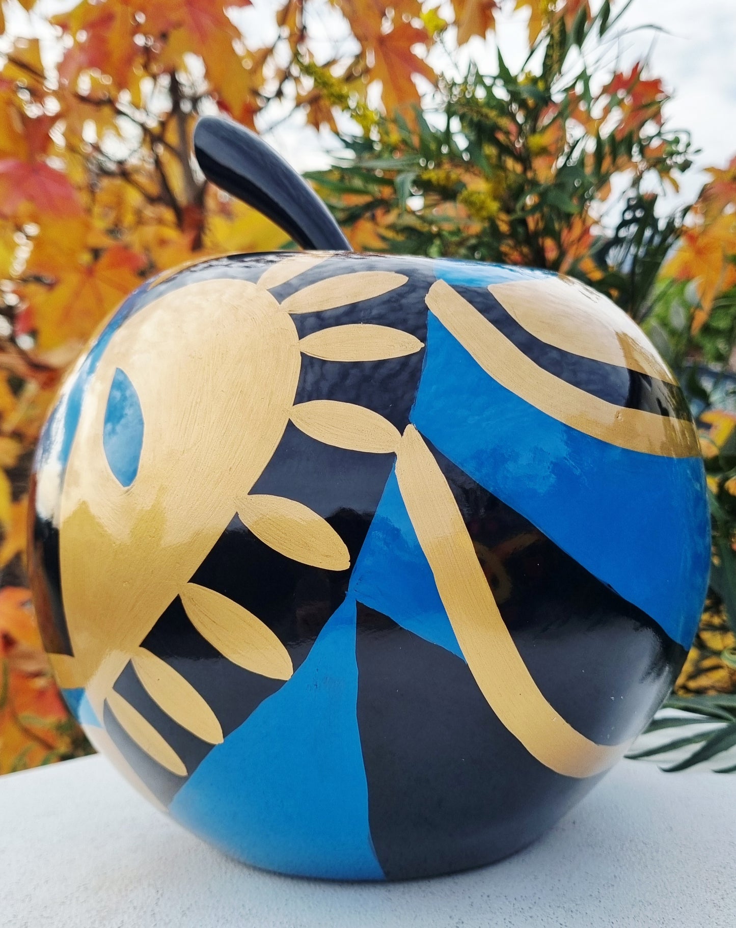 Fruit sculpture. Blue, black and golden apple, multicolored resin. Height 26 centimeters (10,2 inches)