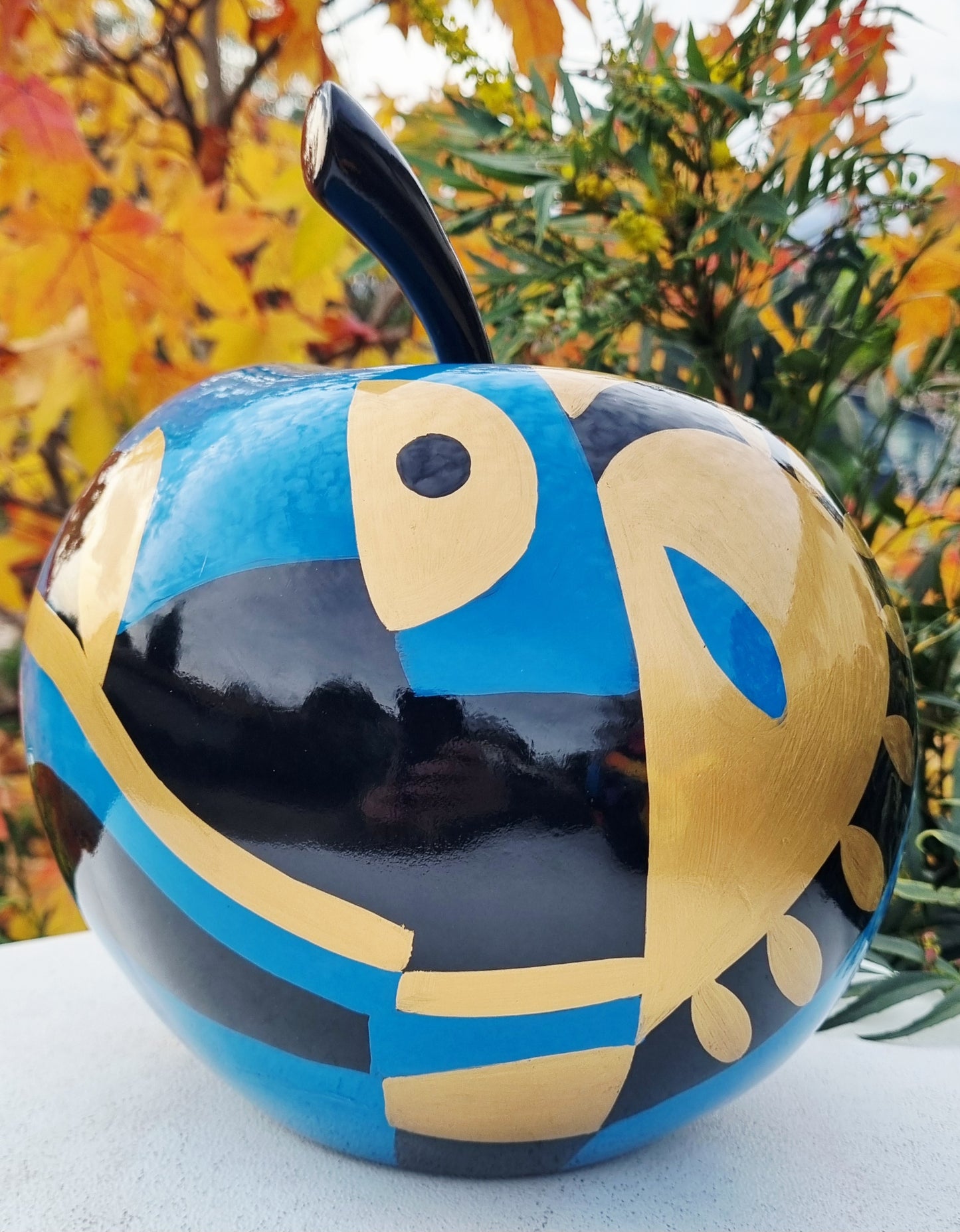 Fruit sculpture. Blue, black and golden apple, multicolored resin. Height 26 centimeters (10,2 inches)