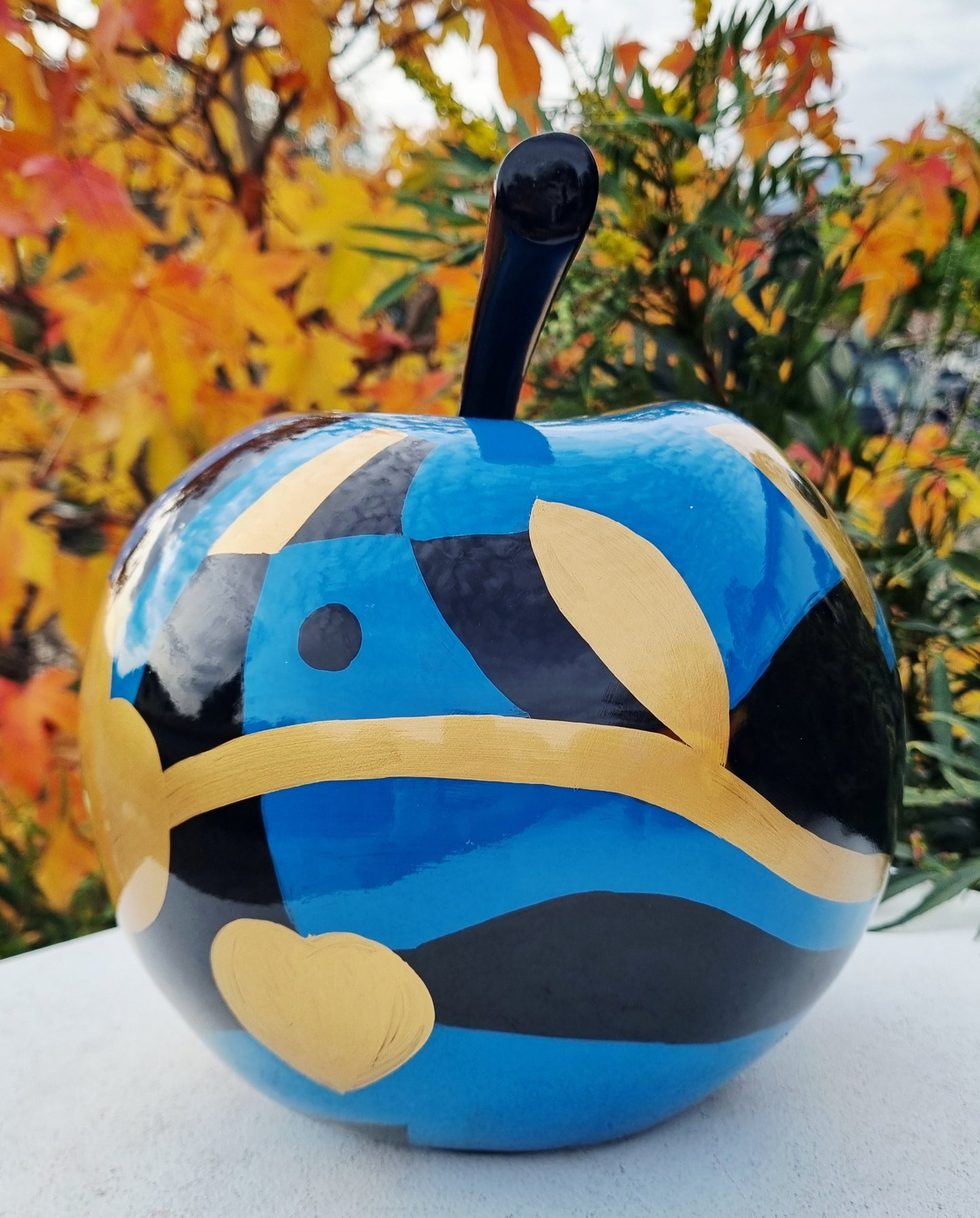 Fruit sculpture. Blue, black and golden apple, multicolored resin. Height 26 centimeters (10,2 inches)